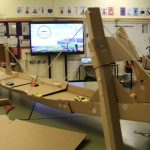 toys cars on a bridge made of cardboard