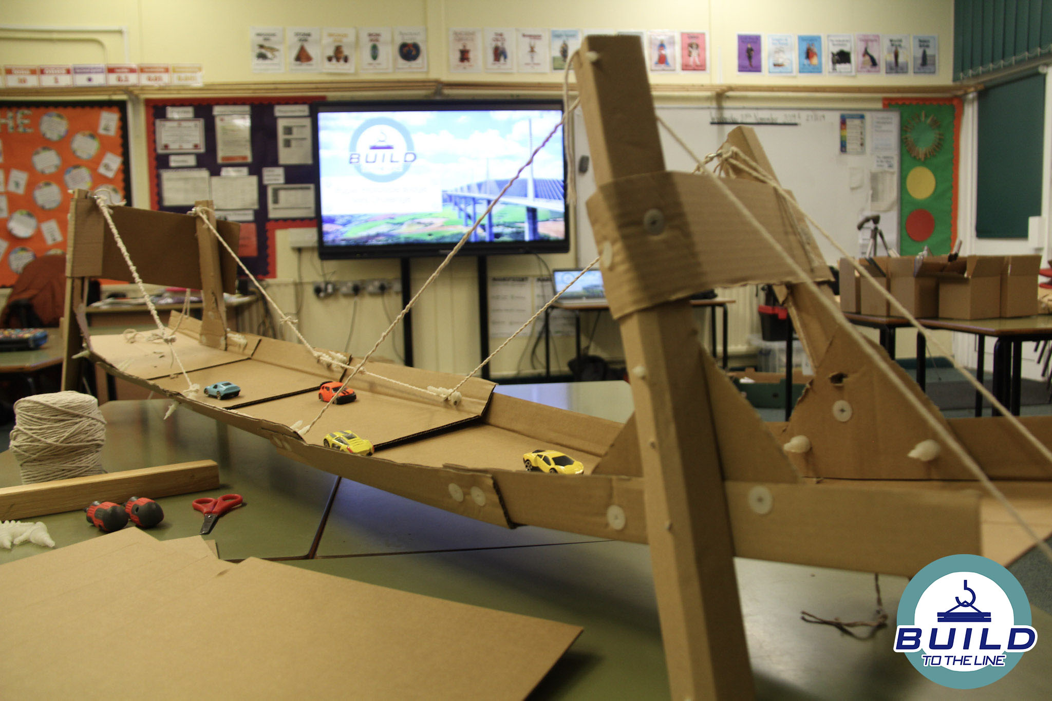 toys cars on a bridge made of cardboard